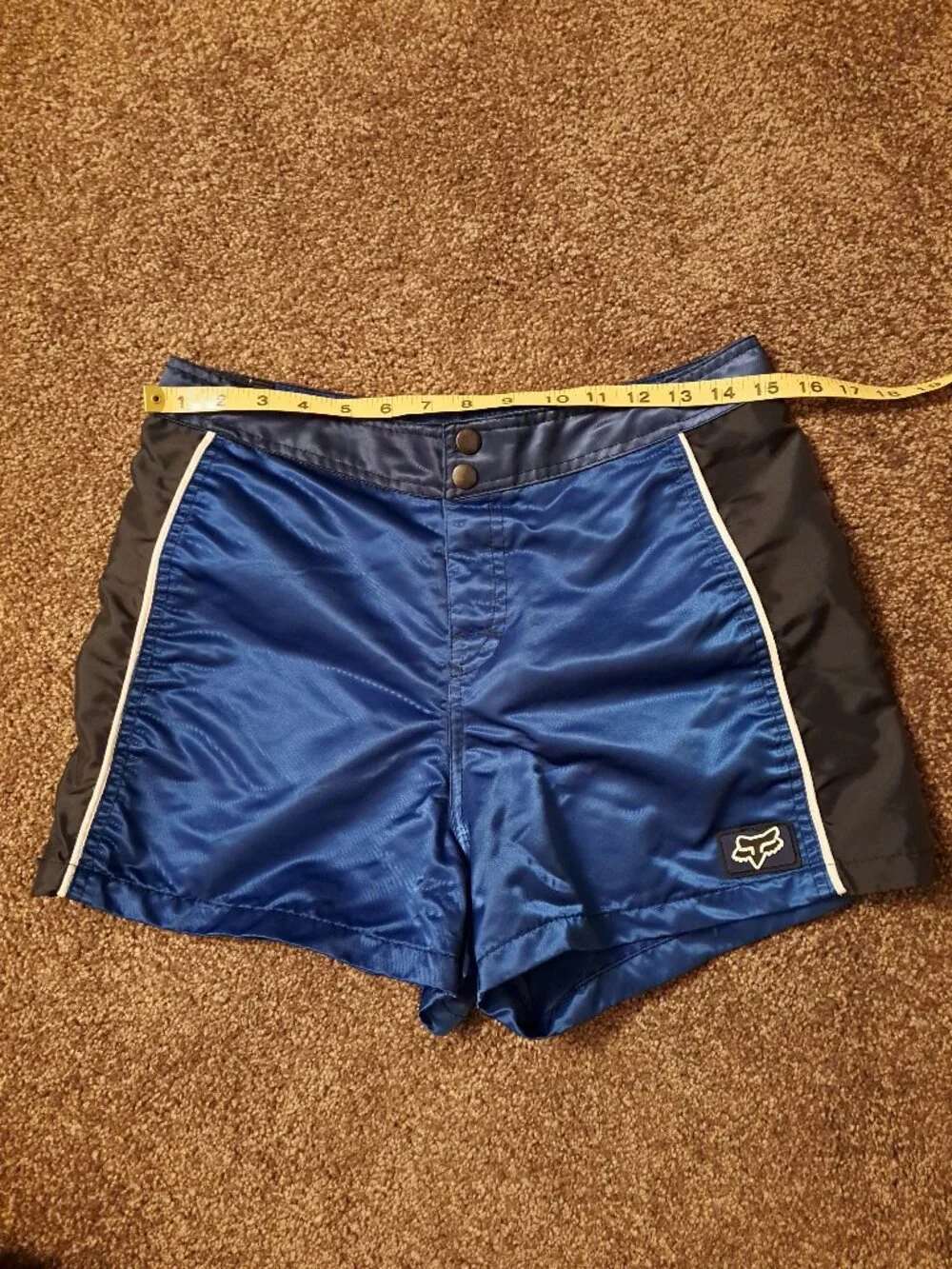 Vintage Fox Racing board shorts featuring a blue satin finish &white piping.